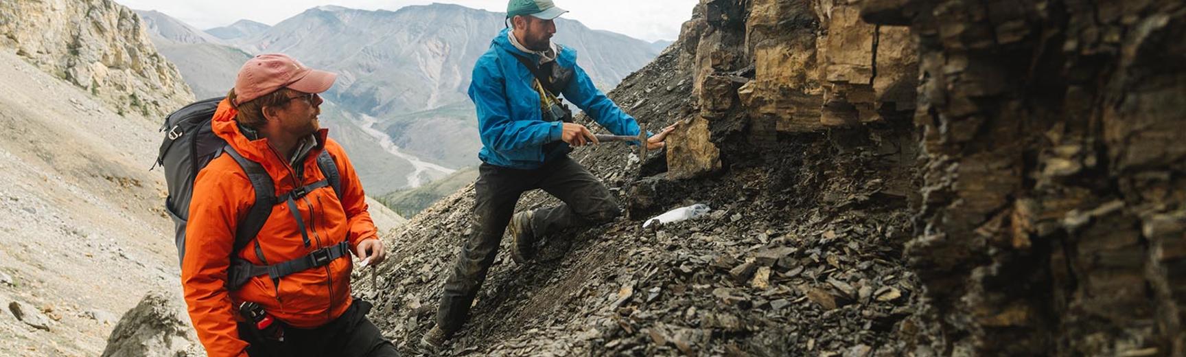 Two researchers studying rocks in the Mackenzie mountains