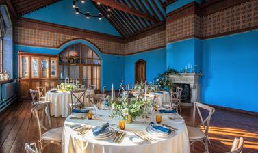 Round tables set up in the Westwood Room for a celebration