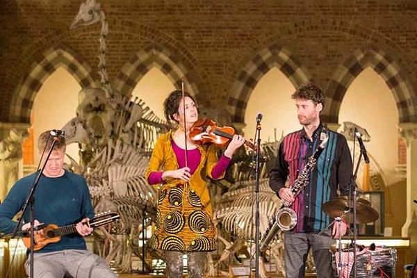 A group of musicians playing in the main court of the museum