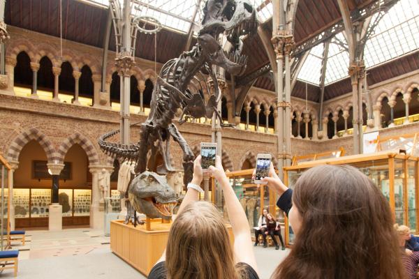 Students filming the T rex