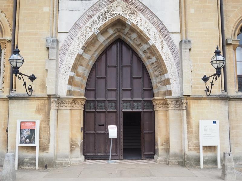 The Main entrance of the Museum, a large set of wooden doors with nature stone carvings around them