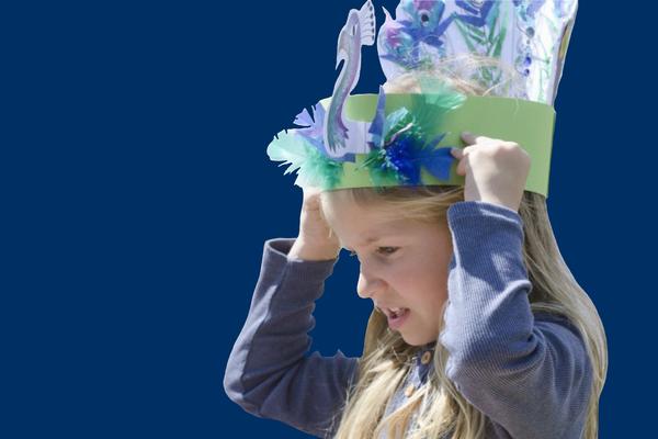 Girl wearing paper peacock headdress 