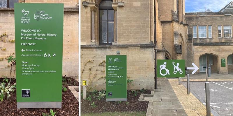 Freestanding green welcome sign on a lawn outside the Oxford University Museum of Natural History displaying opening hours, free entry information, and directions to the accessible entrance.